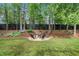 Backyard view showcasing a cozy fire pit area with seating, perfect for outdoor gatherings at 674 Owl Creek Ct, Powder Springs, GA 30127