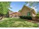 A well-manicured backyard with a covered patio and pergola, perfect for outdoor entertaining at 674 Owl Creek Ct, Powder Springs, GA 30127