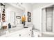 Neutral bathroom features a vanity with granite countertops, mirror, and a glass enclosed shower at 674 Owl Creek Ct, Powder Springs, GA 30127
