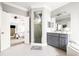 Bathroom view showcasing a walk-in shower, vanity, and doorway into the bedroom at 674 Owl Creek Ct, Powder Springs, GA 30127
