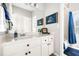 Bathroom with a single vanity, ship artwork, and a shower with a blue curtain at 674 Owl Creek Ct, Powder Springs, GA 30127