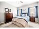 Cozy bedroom with a comfortable bed, chest of drawers, and a window at 674 Owl Creek Ct, Powder Springs, GA 30127