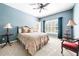 Bedroom featuring a ceiling fan, shuttered windows, and bedside tables with lamps at 674 Owl Creek Ct, Powder Springs, GA 30127