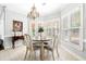 Bright breakfast nook features neutral colors, a chandelier, and large windows with natural light at 674 Owl Creek Ct, Powder Springs, GA 30127