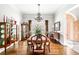 Formal dining room featuring a wooden table, a chandelier, and decorative accents at 674 Owl Creek Ct, Powder Springs, GA 30127