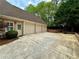 Three-car garage with ample parking and basketball hoop at 674 Owl Creek Ct, Powder Springs, GA 30127
