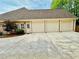 Spacious three-car garage with extended driveway and lush landscaping at 674 Owl Creek Ct, Powder Springs, GA 30127