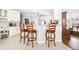 Open kitchen design features white cabinets, pendant lighting, and a breakfast bar with seating at 674 Owl Creek Ct, Powder Springs, GA 30127