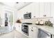Well-equipped kitchen with white cabinets, granite countertops, and stainless steel appliances at 674 Owl Creek Ct, Powder Springs, GA 30127
