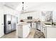 Bright and spacious kitchen with an island, stainless steel appliances, and tiled floors at 674 Owl Creek Ct, Powder Springs, GA 30127