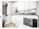 Functional laundry room with a washing machine, a dryer, and storage space at 674 Owl Creek Ct, Powder Springs, GA 30127