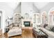 Inviting living room features a fireplace, built-in shelving, and ample natural light at 674 Owl Creek Ct, Powder Springs, GA 30127