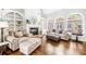 Warm living room features a cozy fireplace, arched windows, and beautiful hardwood floors at 674 Owl Creek Ct, Powder Springs, GA 30127