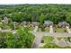 An aerial view of the neighborhood, showcasing mature trees and well-maintained homes along a winding street at 7020 Grand View Way, Suwanee, GA 30024