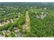 Aerial view showcasing a lush golf course surrounded by trees and homes, with well-maintained fairways and greens at 7020 Grand View Way, Suwanee, GA 30024