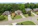 An aerial view showcases the brick home, manicured lawns, driveways, and the well-maintained streetscape at 7020 Grand View Way, Suwanee, GA 30024