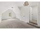 Finished attic space with carpeting, natural light, and modern chandelier at 7020 Grand View Way, Suwanee, GA 30024