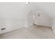 Spacious finished attic with carpeting and natural light; modern chandelier at 7020 Grand View Way, Suwanee, GA 30024