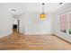 Bright dining room with hardwood floors, wainscoting and modern light fixture at 7020 Grand View Way, Suwanee, GA 30024