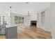 Bright living room with built-in shelves, stone fireplace, and hardwood floors at 7020 Grand View Way, Suwanee, GA 30024