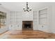 Bright living room with built-in shelves, stone fireplace, and hardwood floors at 7020 Grand View Way, Suwanee, GA 30024