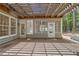Covered back patio featuring wood trellis, large windows and access to backyard at 7020 Grand View Way, Suwanee, GA 30024