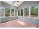Cozy sun room with ample natural light from large windows and a ceiling fan to keep you cool on hot summer days at 7020 Grand View Way, Suwanee, GA 30024