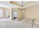 Open living room with natural light and neutral colors, a hanging chandelier, and carpet at 1250 Parkwood Se Cir # 300, Atlanta, GA 30339