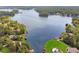 An aerial view of lakefront homes with docks and boats surrounded by lush greenery and mature trees at 2019 Emerald Dr, Jonesboro, GA 30236