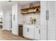 Stylish bar area with a wine cooler, custom cabinetry, marble countertops, and wood shelving at 2019 Emerald Dr, Jonesboro, GA 30236