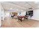 Finished basement with a pool table, brick fireplace, and cozy seating area at 2019 Emerald Dr, Jonesboro, GA 30236