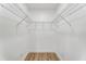 Empty walk-in closet with wire shelves, white walls, and wood grain vinyl floors ready for organization at 2019 Emerald Dr, Jonesboro, GA 30236