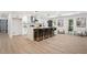 Spacious kitchen with marble island, modern appliances, pendant lights, and a sitting area with a backyard view at 2019 Emerald Dr, Jonesboro, GA 30236