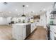 Large, open kitchen with marble island, pendant lighting, stainless steel appliances, and an adjacent living room at 2019 Emerald Dr, Jonesboro, GA 30236