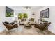 Modern living room with stylish seating, decorative art, and large window showcasing scenic outdoor views and natural light at 2019 Emerald Dr, Jonesboro, GA 30236