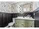 Charming powder room featuring decorative wallpaper, board and batten, and a green vanity at 2019 Emerald Dr, Jonesboro, GA 30236