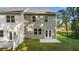 A view of the backyard features a well-maintained lawn, a small patio, and neutral siding at 349 Elgin Dr, Lawrenceville, GA 30045