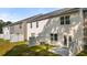 Rear elevation of townhomes showcasing patios and white fence at 349 Elgin Dr, Lawrenceville, GA 30045