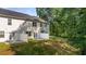 A serene backyard featuring a grass lawn, fenced area, and the building's exterior at 349 Elgin Dr, Lawrenceville, GA 30045