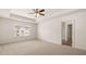 Bright bedroom features neutral carpet, a ceiling fan, and a window with neighborhood views at 349 Elgin Dr, Lawrenceville, GA 30045
