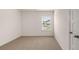A bright bedroom featuring a window and neutral carpeting at 349 Elgin Dr, Lawrenceville, GA 30045