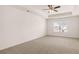 Bright bedroom features neutral carpet, a ceiling fan, and a window with neighborhood views at 349 Elgin Dr, Lawrenceville, GA 30045