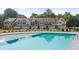 Community pool area with comfortable seating with a backdrop of charming townhomes and landscaping at 349 Elgin Dr, Lawrenceville, GA 30045