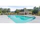 View of the community pool and amenity center with a view of the surrounding landscaping at 349 Elgin Dr, Lawrenceville, GA 30045