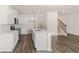 Modern kitchen with white cabinets, stainless steel appliances, an island, and access to stairs at 349 Elgin Dr, Lawrenceville, GA 30045