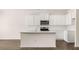Modern kitchen features white cabinetry, stainless steel appliances, and an island at 349 Elgin Dr, Lawrenceville, GA 30045