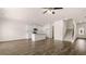 Open-concept living area featuring a kitchen, living room, and staircase with wood-style flooring at 349 Elgin Dr, Lawrenceville, GA 30045