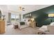 Bright main bedroom with tray ceilings, neutral colors and comfortable seating and furnishings at 349 Elgin Dr, Lawrenceville, GA 30045