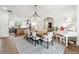 A spacious dining room features wood flooring, a formal dining table, and a white baby grand piano at 3667 Peachtree Ne Rd # 6, Atlanta, GA 30319