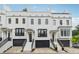 Charming townhome featuring black garages, light brick, and elegant stairway and stoop at 3667 Peachtree Ne Rd # 6, Atlanta, GA 30319